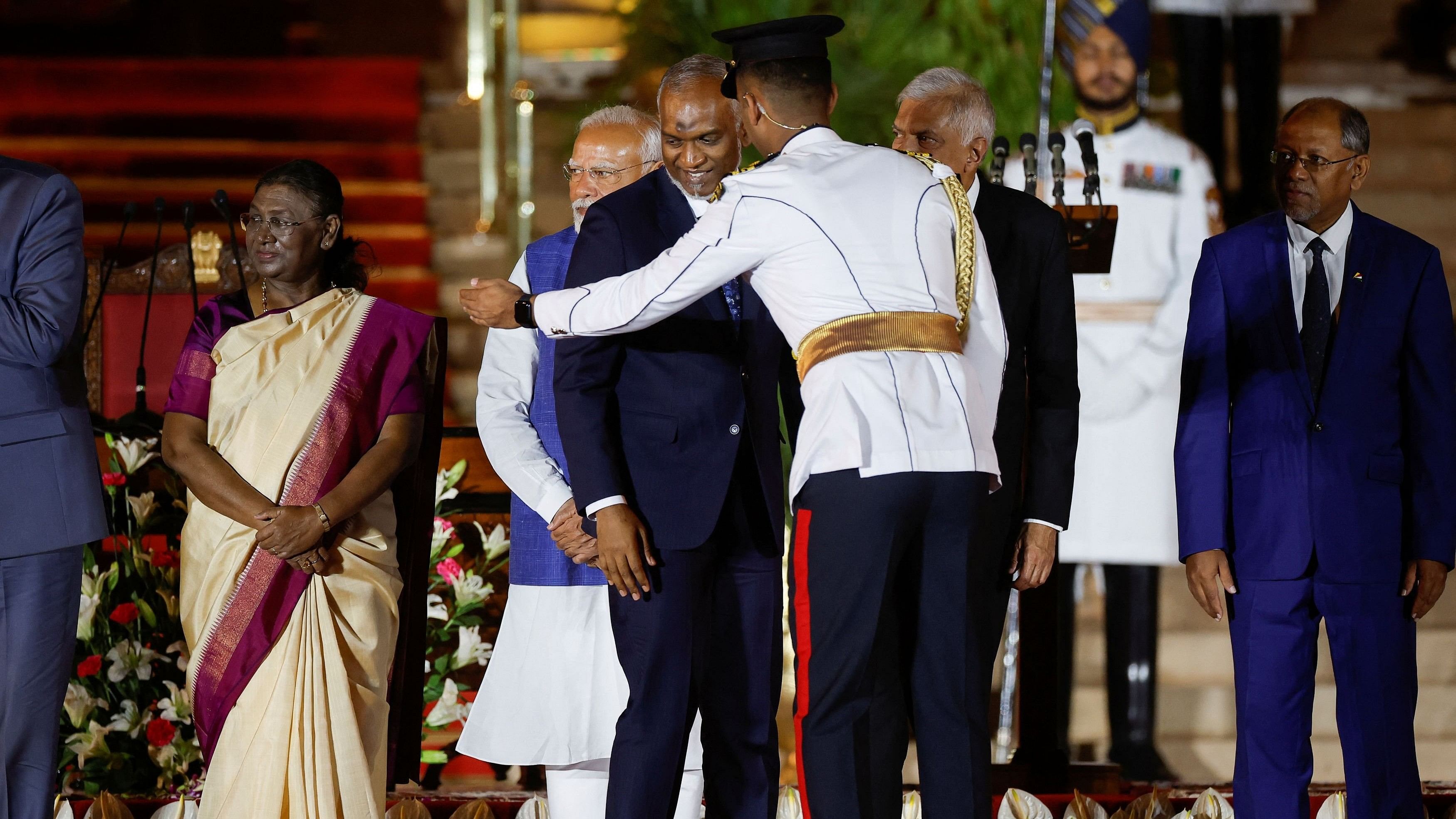 <div class="paragraphs"><p>India's President Droupadi Murmu and Prime Minister Narendra Modi stand near Maldives' President Mohamed Muizzu, during a swearing-in ceremony at the presidential palace in New Delhi.</p></div>