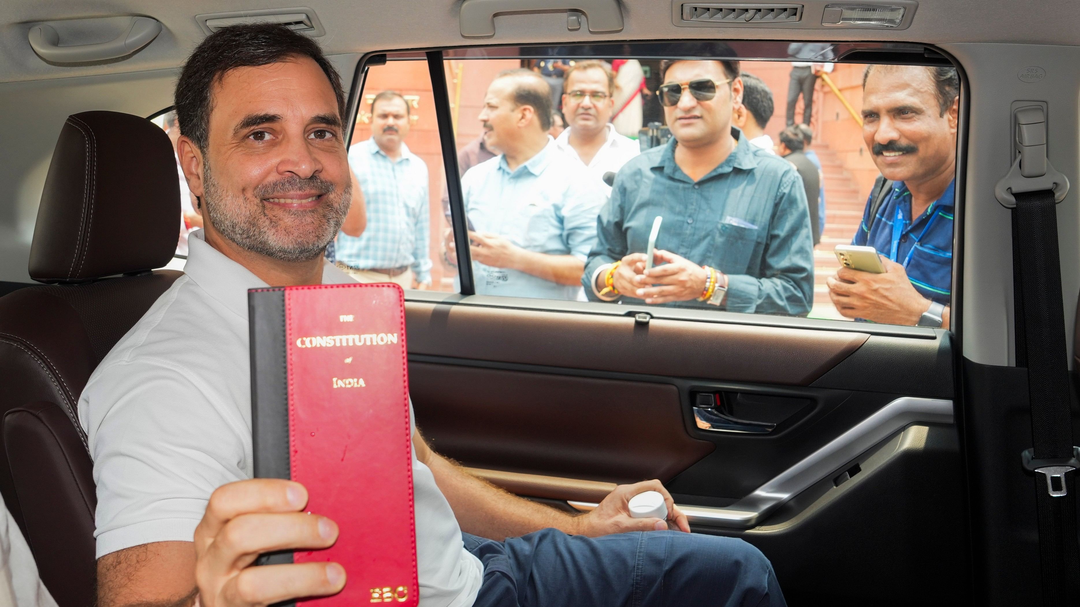 <div class="paragraphs"><p>Congress member Rahul Gandhi shows a book of Constitution of India at the Parliament House complex on the first day of the first session of the 18th Lok Sabha, in New Delhi.</p></div>