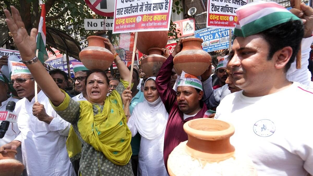 <div class="paragraphs"><p>ongress workers carry earthen pots during a ‘Matka Phod’ protest against the ongoing water crisis, in New Delhi</p></div>