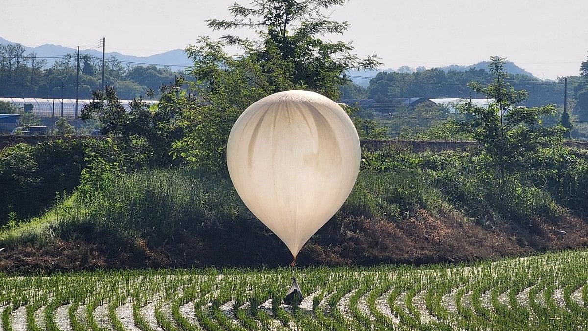 <div class="paragraphs"><p>A balloon believed to have been sent by North Korea, carrying various objects including what appeared to be trash and excrement, is seen over a rice field at Cheorwon, South Korea.</p></div>