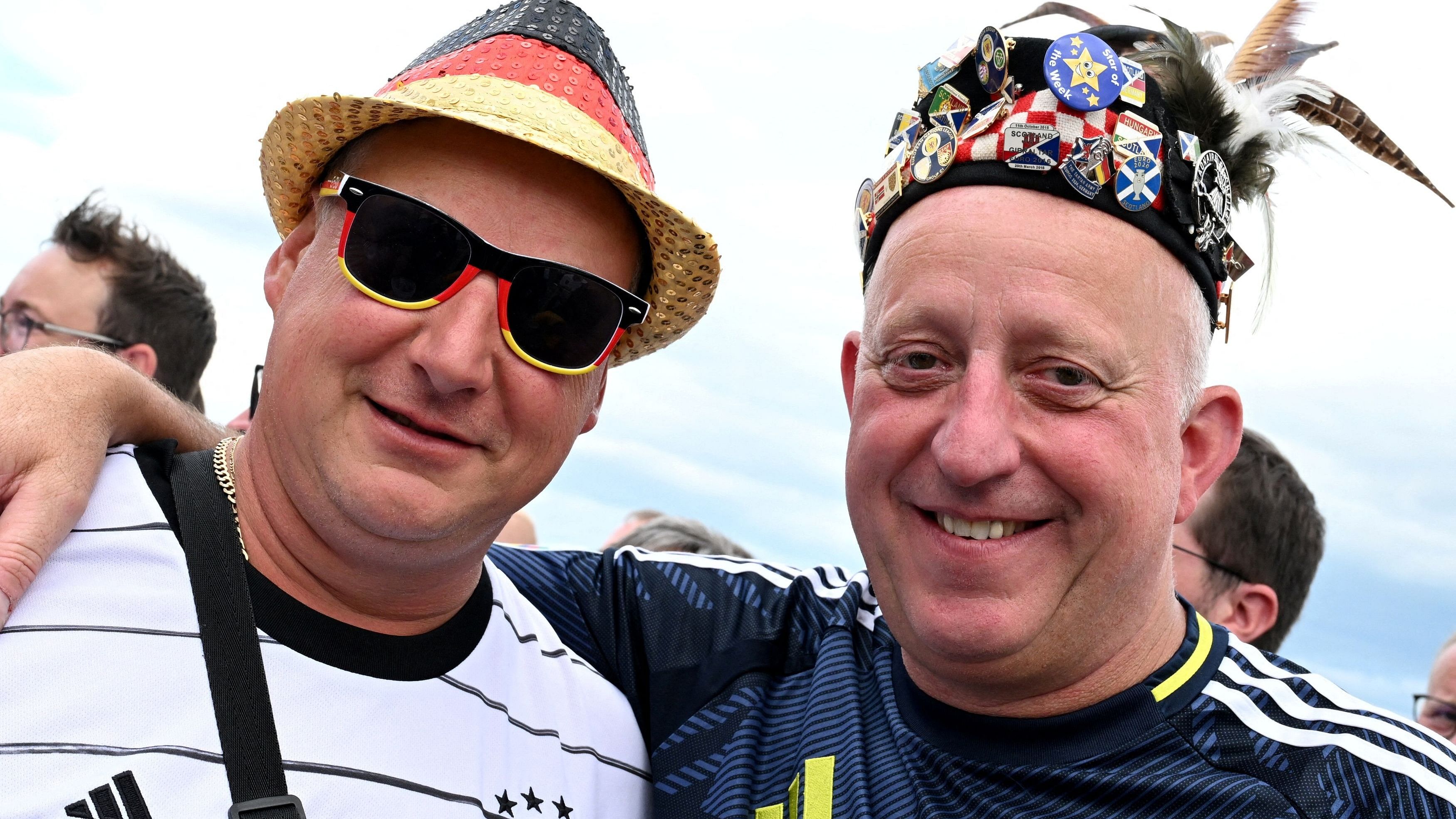 <div class="paragraphs"><p>A Germany fan with a Scotland fan outside the stadium before the match.</p></div>