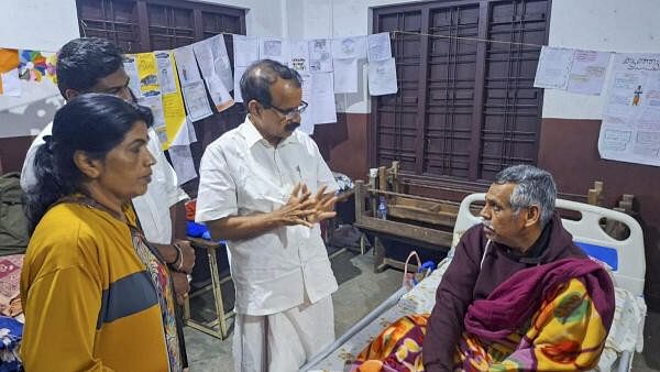 <div class="paragraphs"><p>Union Minister George Kurien interacts with a landslide survivor during a visit to a relief camp, in Wayanad, Wednesday, July 31, 2024.</p></div>