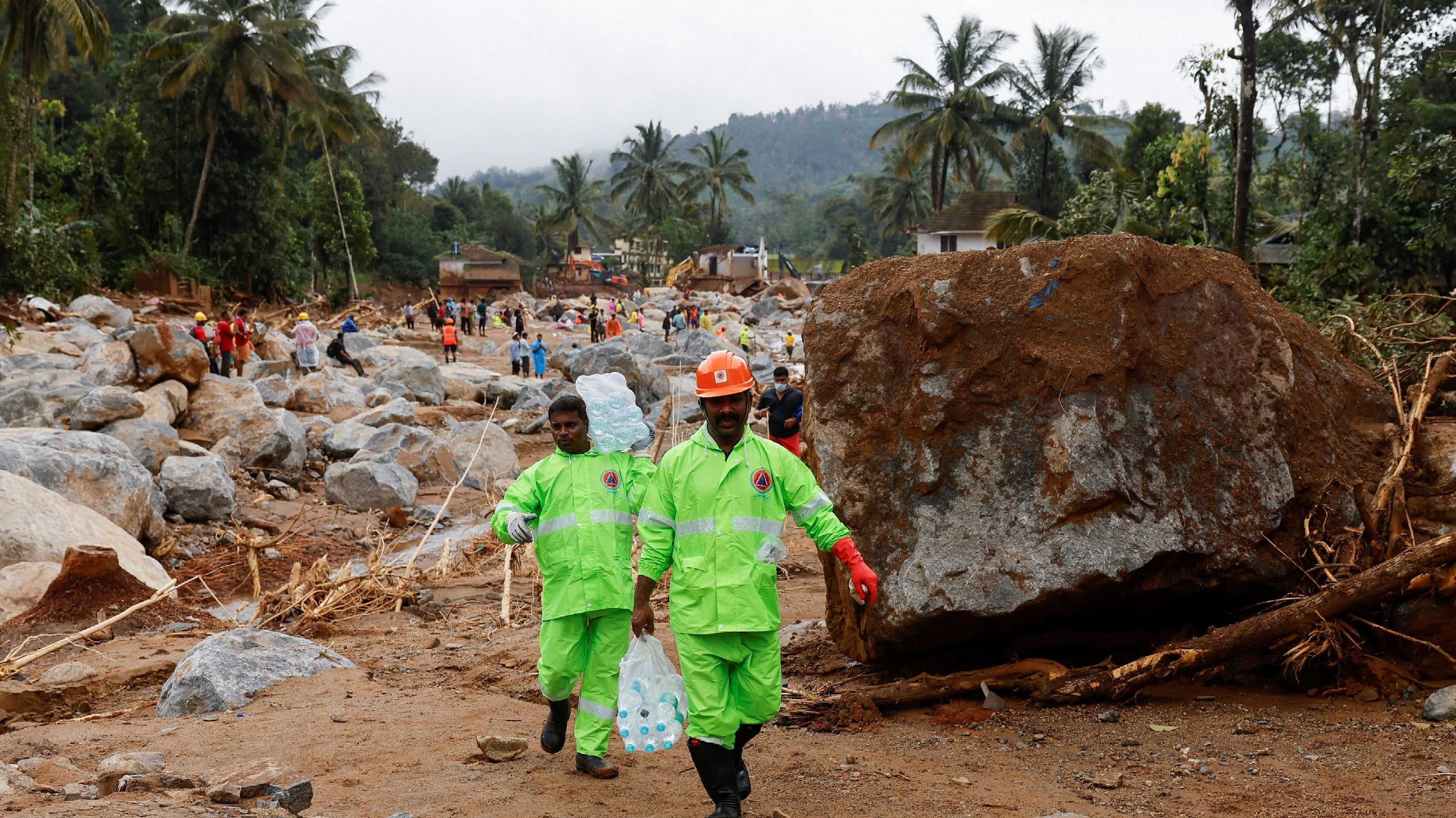 <div class="paragraphs"><p>Volunteers carry water bottles to distribute to rescue teams, after several landslides hit the hills in Wayanad district.</p></div>