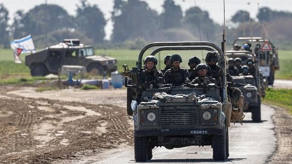 <div class="paragraphs"><p>Israeli military vehicles drive towards Gaza</p></div>