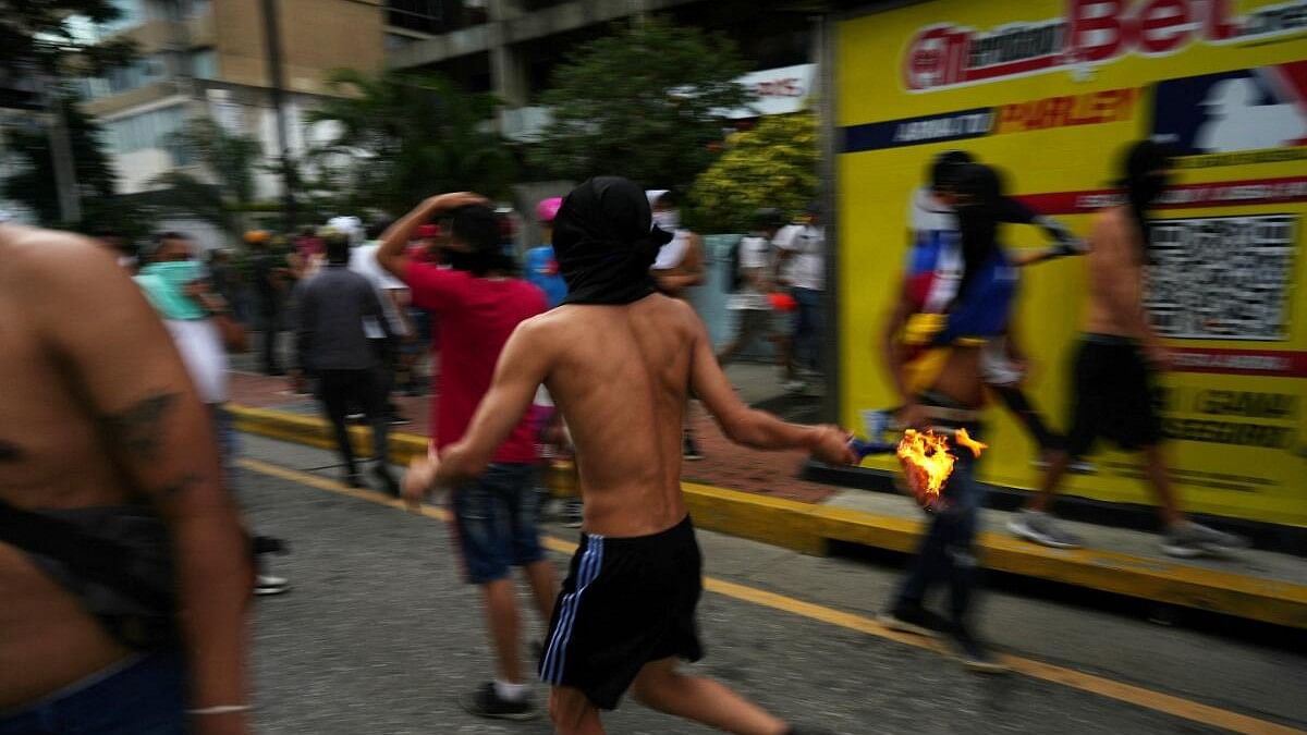 <div class="paragraphs"><p>Supporters of the Venezuelan opposition demonstrate following the announcement that Venezuela's President Maduro won the presidential election, in Caracas.</p></div>