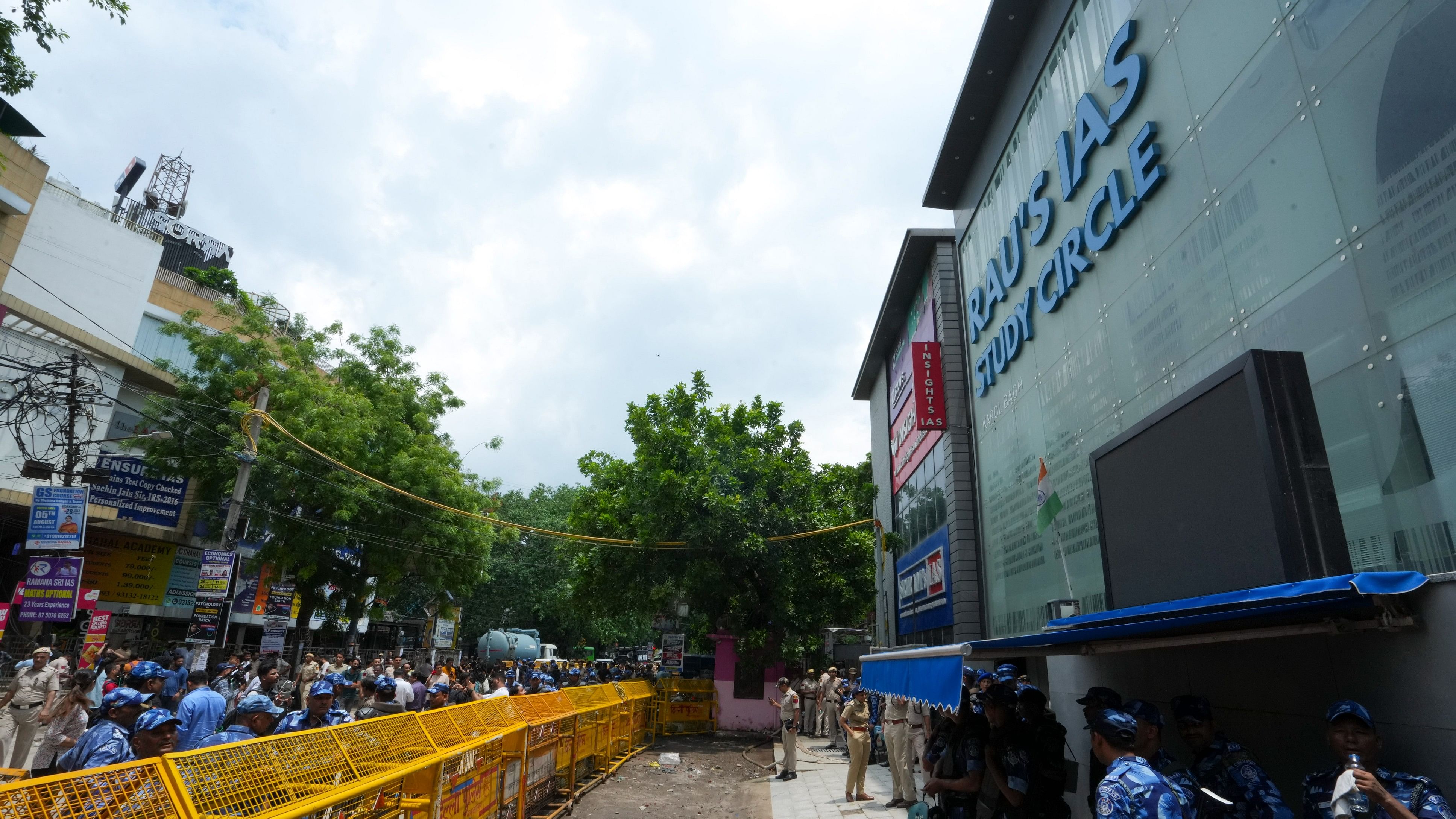 <div class="paragraphs"><p>Security personnel stand guard near a UPSC exam coaching centre after three civil services aspirants died when the basement of the coaching centre was flooded by rainwater, in New Delhi, Sunday, July 28, 2024.</p></div>