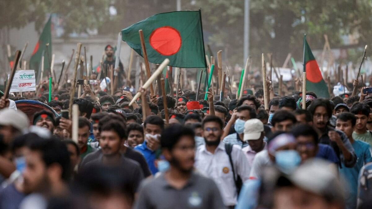 <div class="paragraphs"><p>Anti-quota protesters march with Bangladeshi flags and sticks.</p></div>