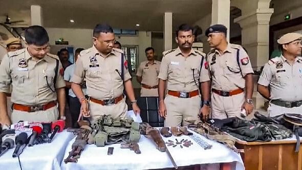 <div class="paragraphs"><p>Police personnel display the arms and ammunition recovered after an encounter with alleged Hmar terrorists, in Cachar district of Assam, Wednesday, July 17</p></div>