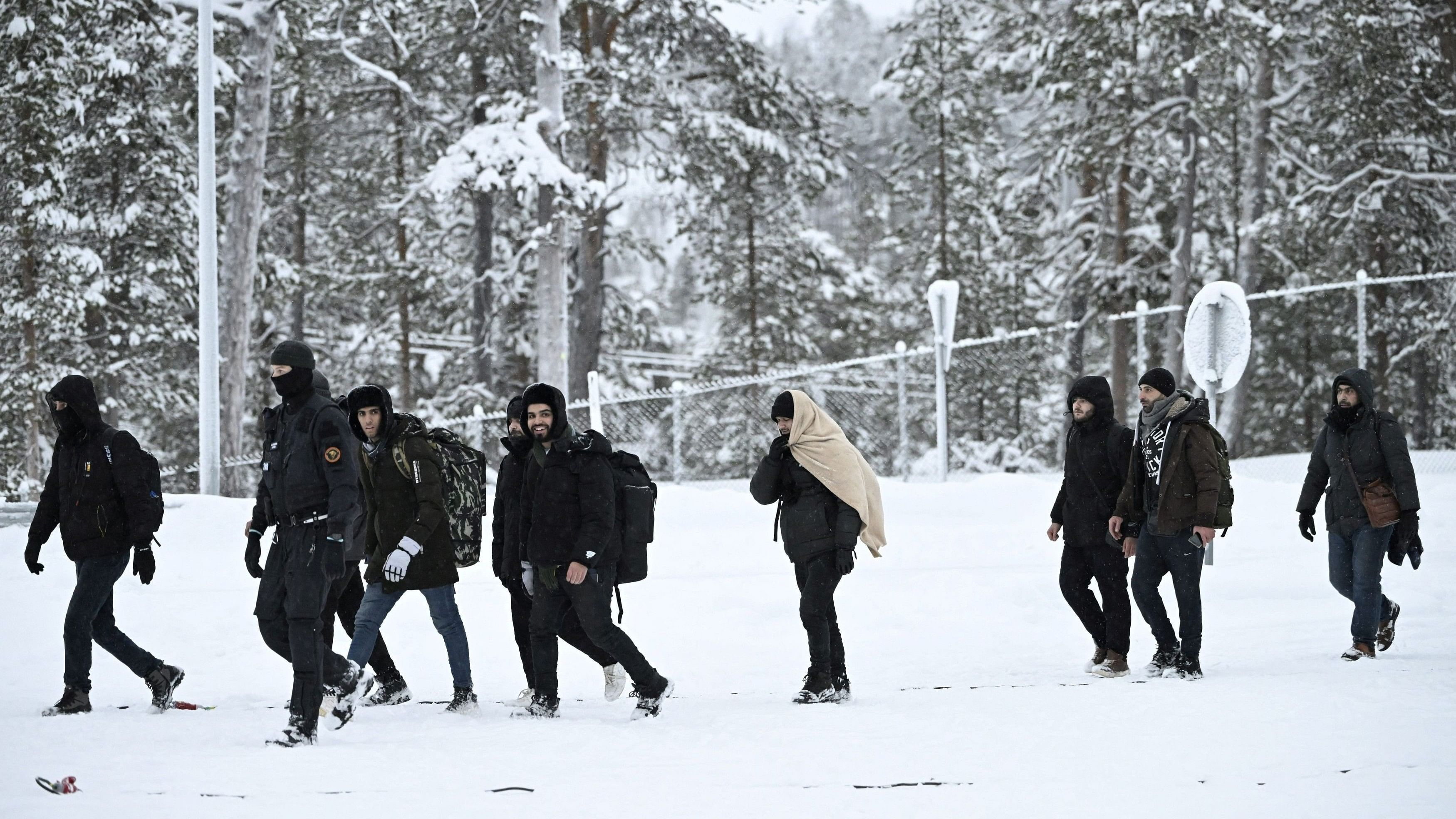 <div class="paragraphs"><p>Representative image showing Finnish Border Guards escorting migrants arriving at the Raja-Jooseppi international border crossing station in Inari, Finland.</p></div>