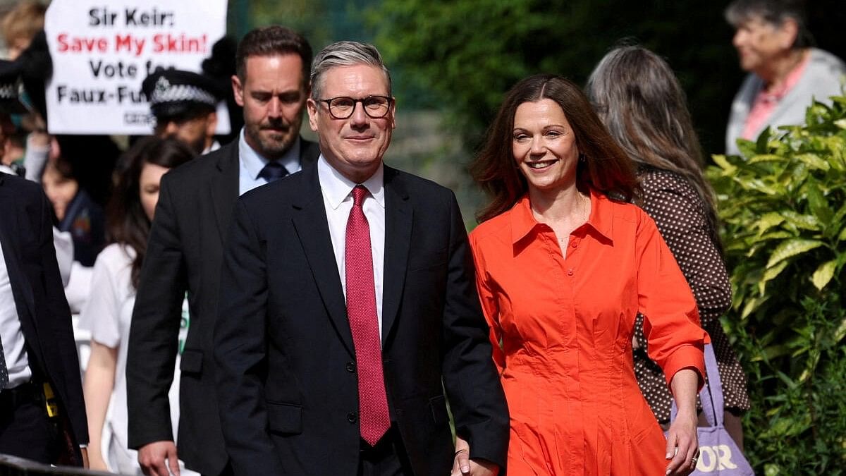 <div class="paragraphs"><p>Britain's opposition Labour Party leader Keir Starmer and his wife Victoria Starmer walk outside a polling station during the general election in London.</p></div>