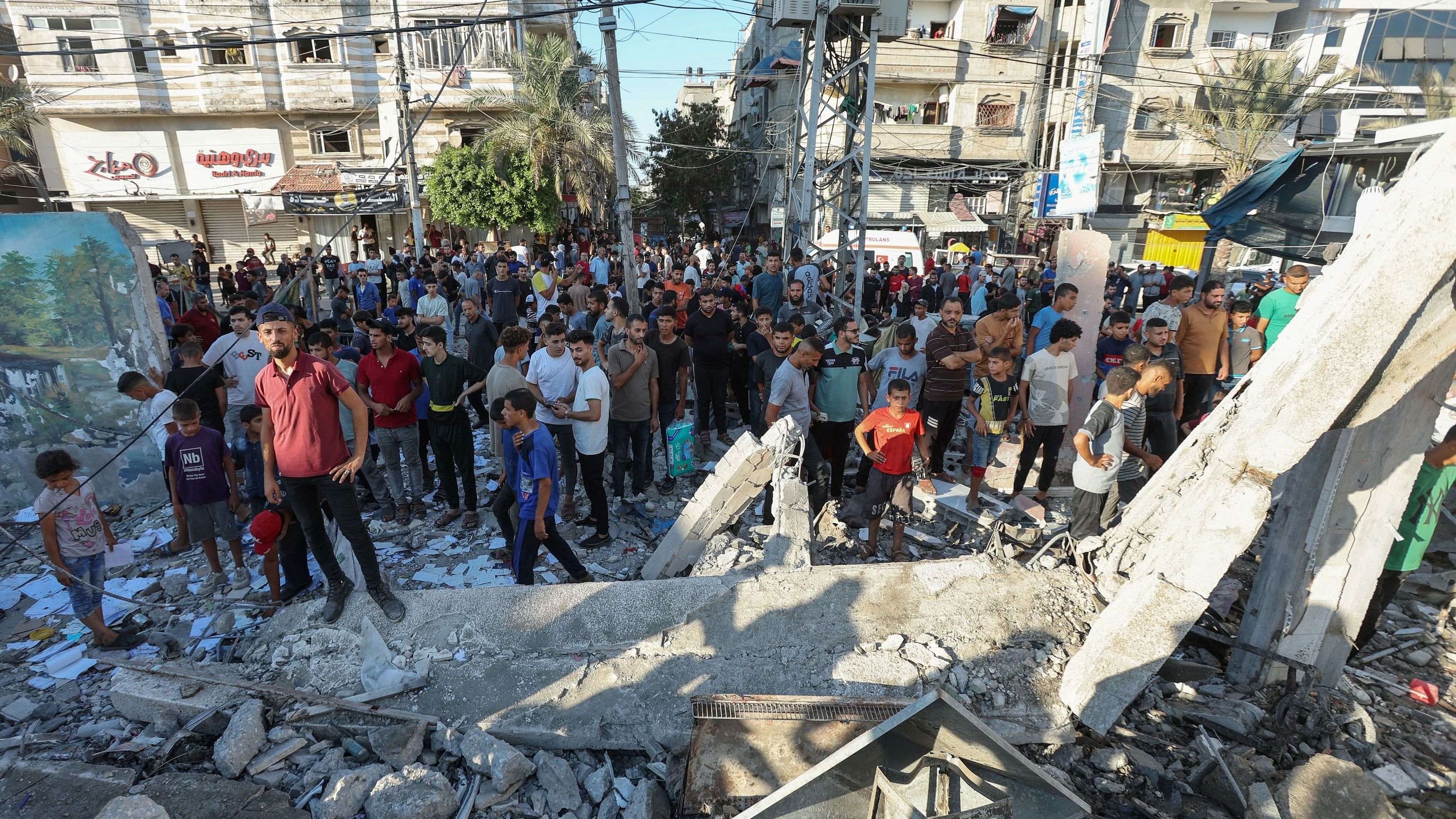 <div class="paragraphs"><p>Palestinians gather at the site of an Israeli air strike on a UN school sheltering displaced people, amid the Israel-Hamas conflict in Nusairat in central Gaza Strip on July 6, 2024. </p></div>