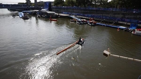 <div class="paragraphs"><p>General view of the river Seine and Alexander III Bridge as workers remove a buoy after Triathlon training was cancelled amid water quality concerns.</p></div>