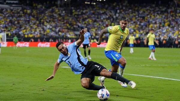 <div class="paragraphs"><p>Uruguay defender Sebastian Caceres (3) moves the ball against Brazil midfielder Bruno Guimaraes (5) during the second half at Allegiant Stadium on July 6, 2024.</p></div>