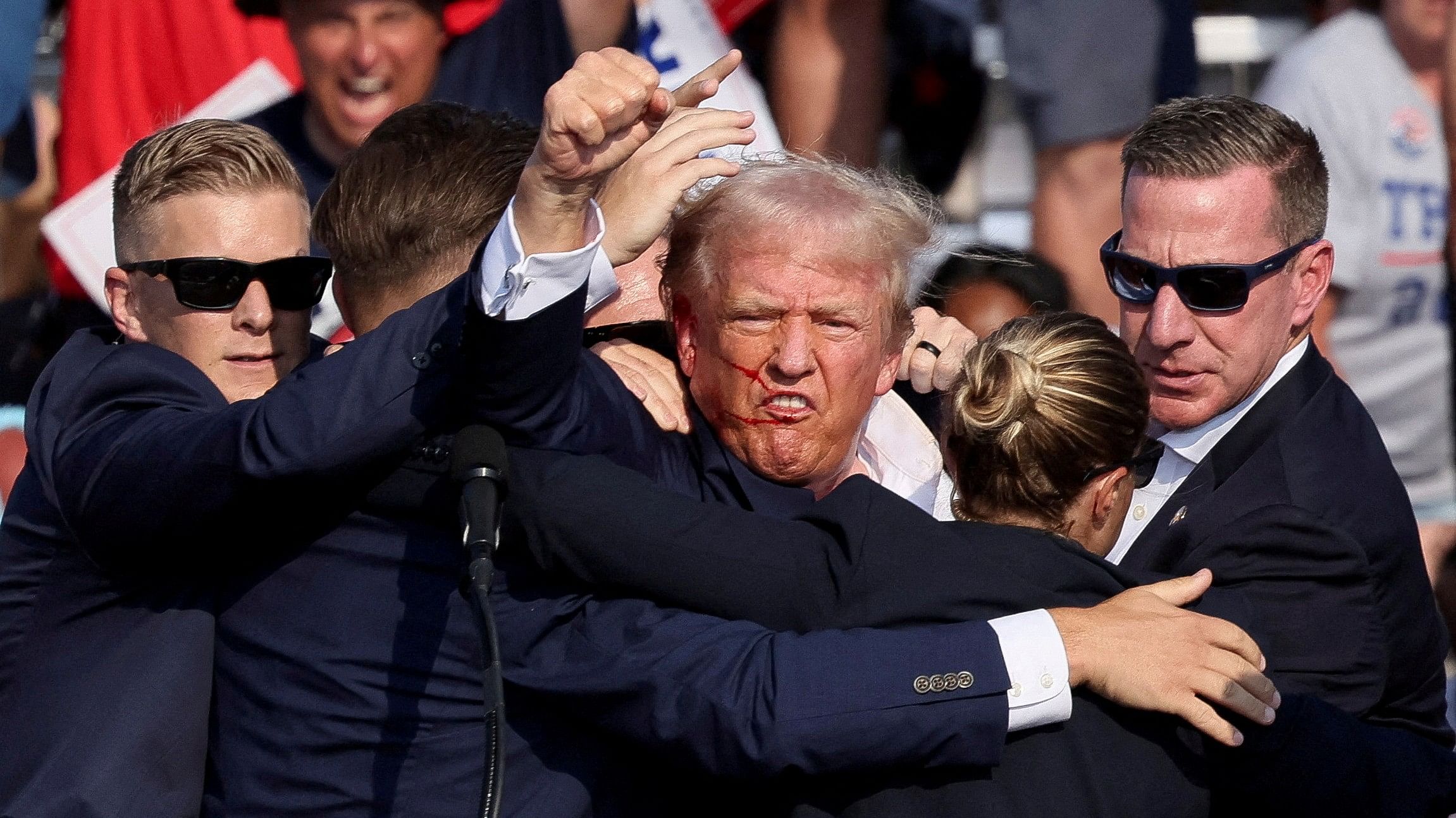 <div class="paragraphs"><p>Republican presidential candidate and former US President Donald Trump is assisted by the Secret Service after gunfire rang out during a campaign rally at the Butler Farm Show in Butler, Pennsylvania, July 13, 2024.</p></div>