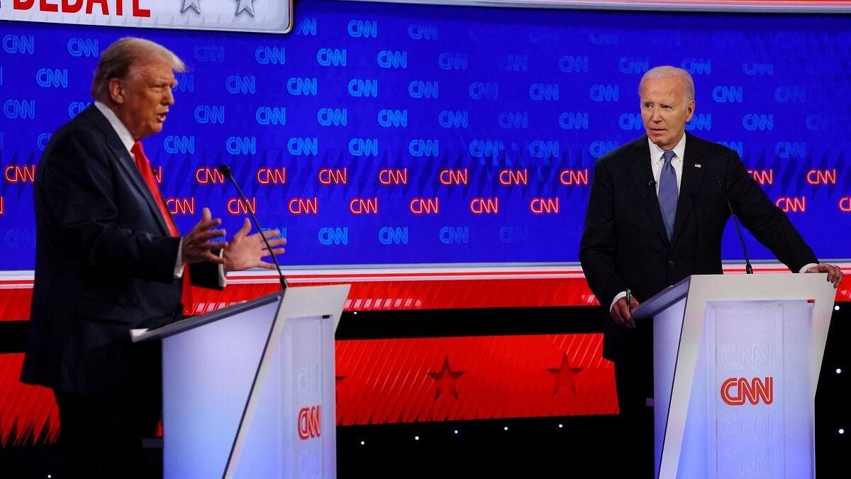 <div class="paragraphs"><p>Democrat presidential candidate US President Joe Biden listens as Republican presidential candidate and former US President Donald Trump speaks during their debate in Atlanta.</p></div>