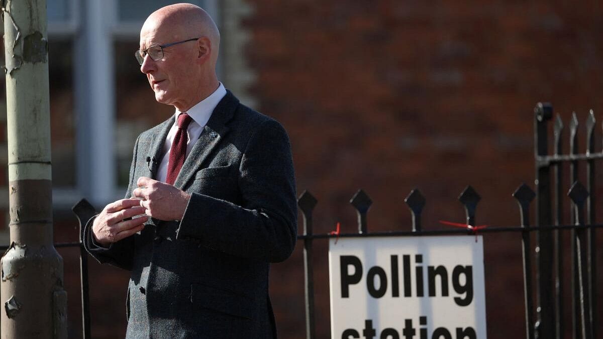 <div class="paragraphs"><p>Leader of the Scottish National Party (SNP) John Swinney stands outside a polling station during the general election in Burrelton, Scotland.</p></div>