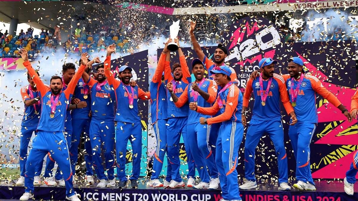 <div class="paragraphs"><p>India's Kuldeep Yadav lifts the trophy as they celebrate after winning the T20 World Cup</p></div>