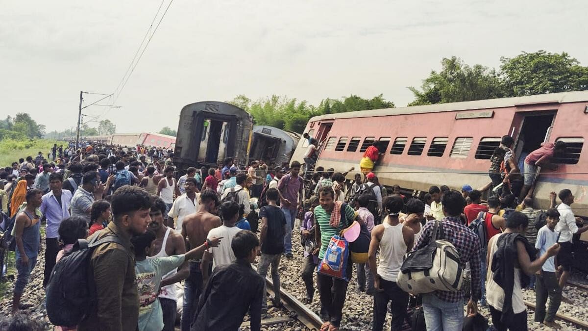 <div class="paragraphs"><p>Passengers and locals near the derailed coaches of the Dibrugarh Express train after an accident, in Gonda district, Thursday, July 18, 2024.</p></div>