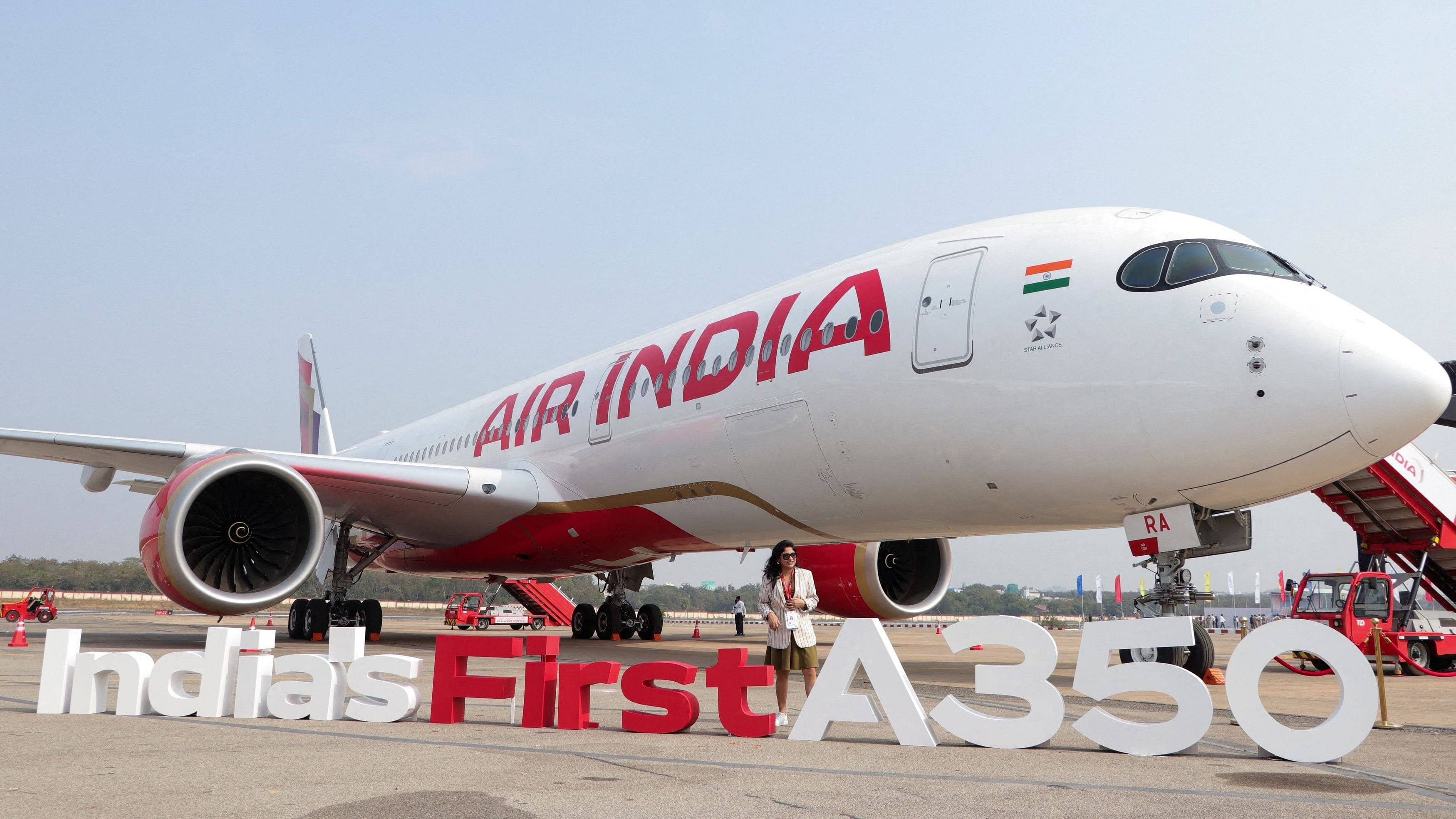 <div class="paragraphs"><p>A woman stands next to the Air India Airbus A350 aeroplane, displayed at Wings India 2024 aviation event at Begumpet airport, Hyderabad, India, January 18, 2024. </p></div>