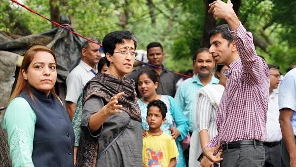 <div class="paragraphs"><p>Delhi Water Minister and AAP leader Atishi, along with Municipal Corporation of Delhi (MCD) Mayor Shelly Oberoi, inspect Drain which overflowed due to rain in New Delhi.</p></div>