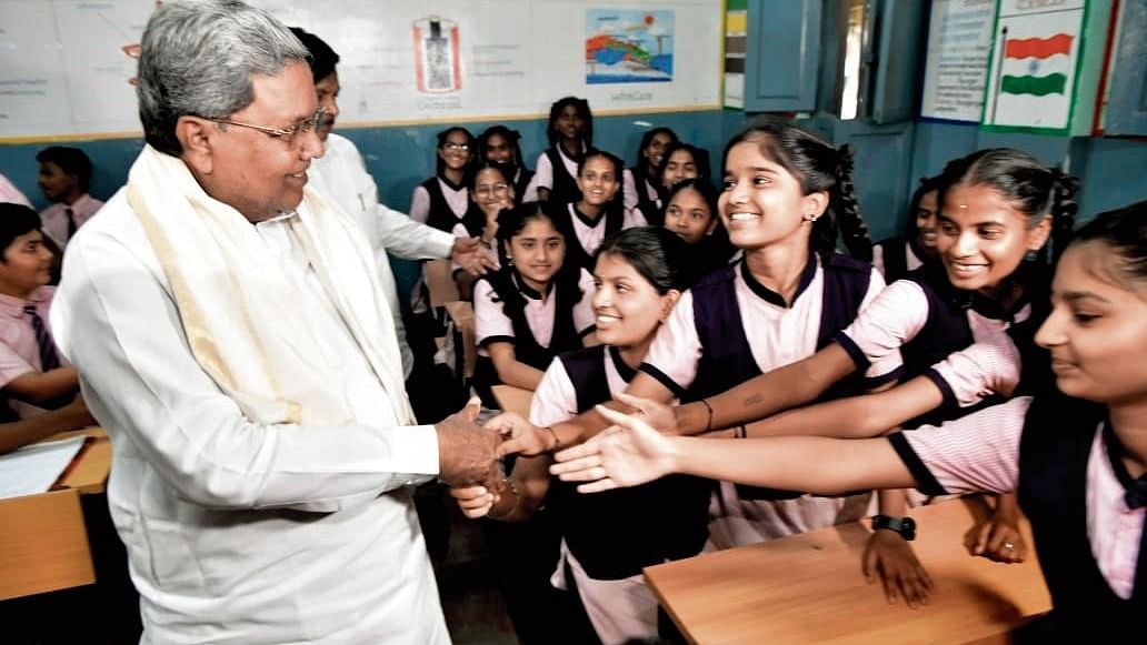 Chief Minister Siddaramaiah interacts with students at Morarji Desai Residential School at Chamarajpet in Bengaluru on Friday.