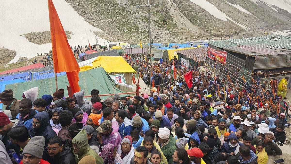 <div class="paragraphs"><p>Devotees stand in queue outside the Amarnath Temple to offer prayers during the annual ‘Amarnath Yatra’, in Anantnag district,</p></div>