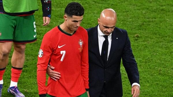 <div class="paragraphs"><p>Portugal coach Roberto Martinez consoles Cristiano Ronaldo after losing the penalty shootout.</p></div>