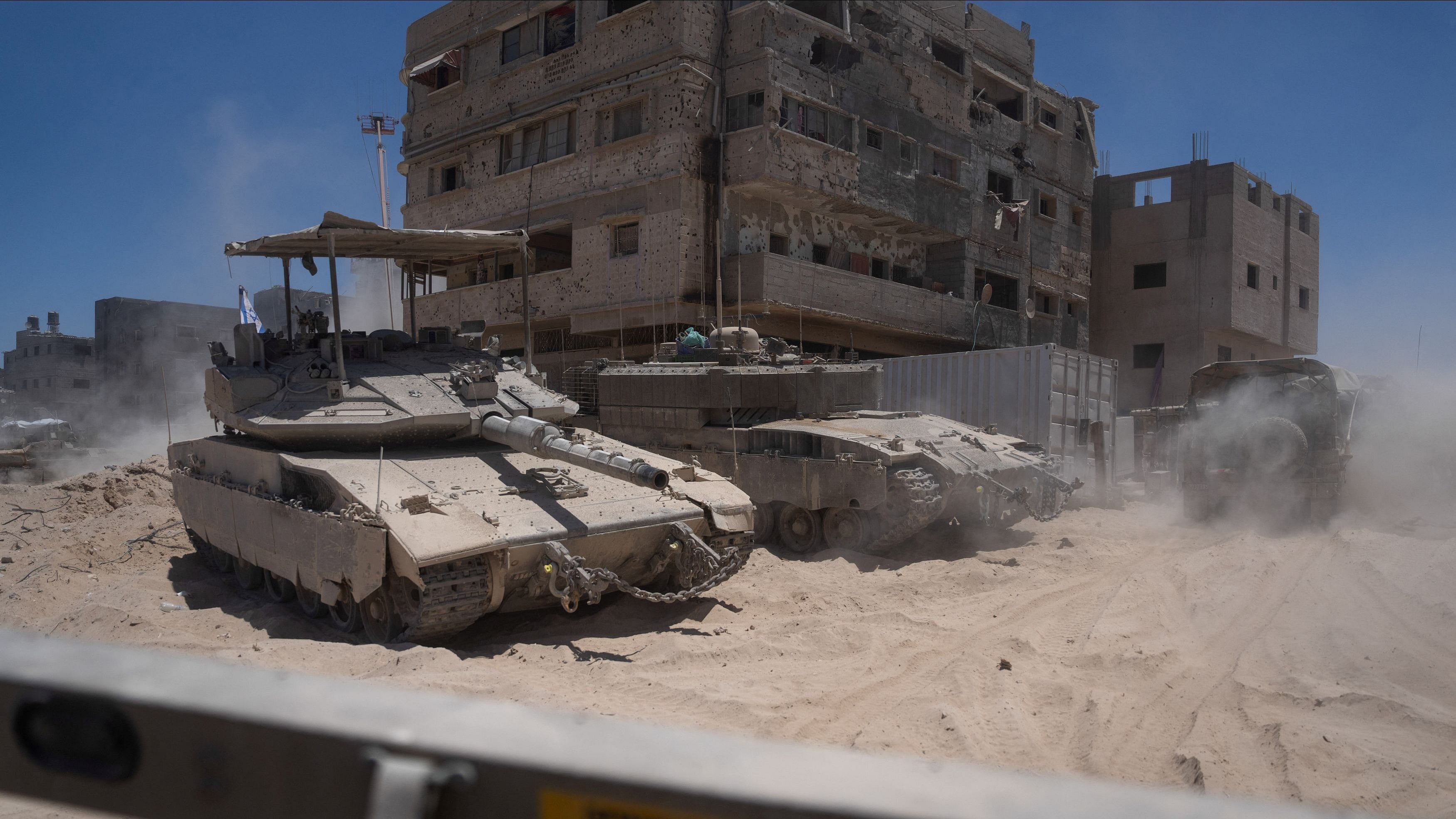 <div class="paragraphs"><p>Israeli tanks operate next to destroyed buildings during a ground operation in the Gaza Strip.</p></div>