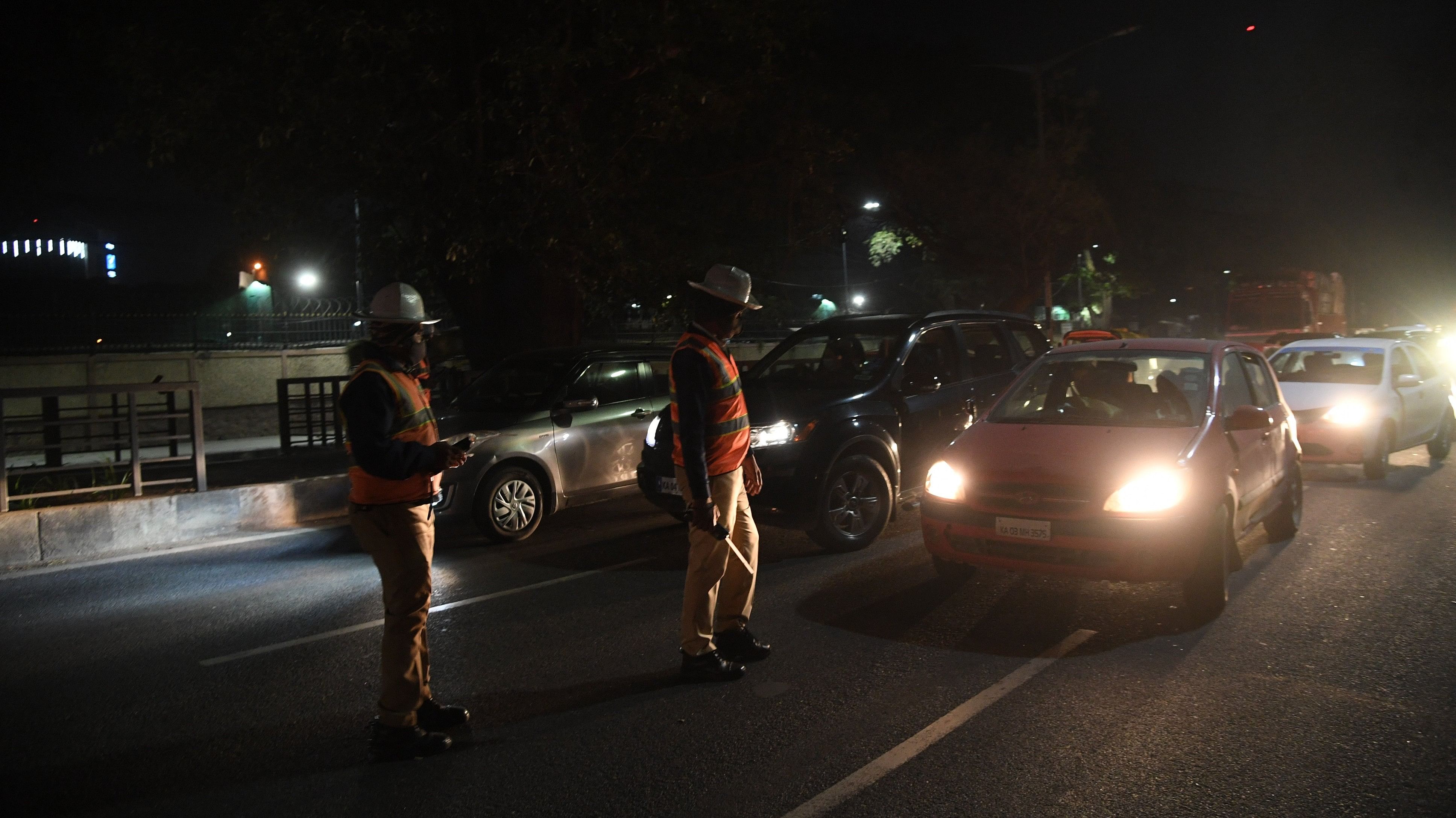 <div class="paragraphs"><p>Police Officials checking in the night, at Rajbhavan Road, in front of KSCA in Bengaluru on Tuesday night. </p></div>