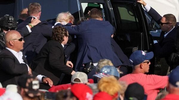 <div class="paragraphs"><p>Republican presidential candidate and former U.S. President Donald Trump gets into a vehicle with the assistance of U.S. Secret Service personnel after he was shot in the right ear during a campaign rally at the Butler Farm Show in Butler, Pennsylvania.</p></div>