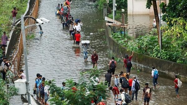 <div class="paragraphs"><p>People walk on a waterlogged street after heavy rains in Mumbai, India, July 8, 2024.</p></div>