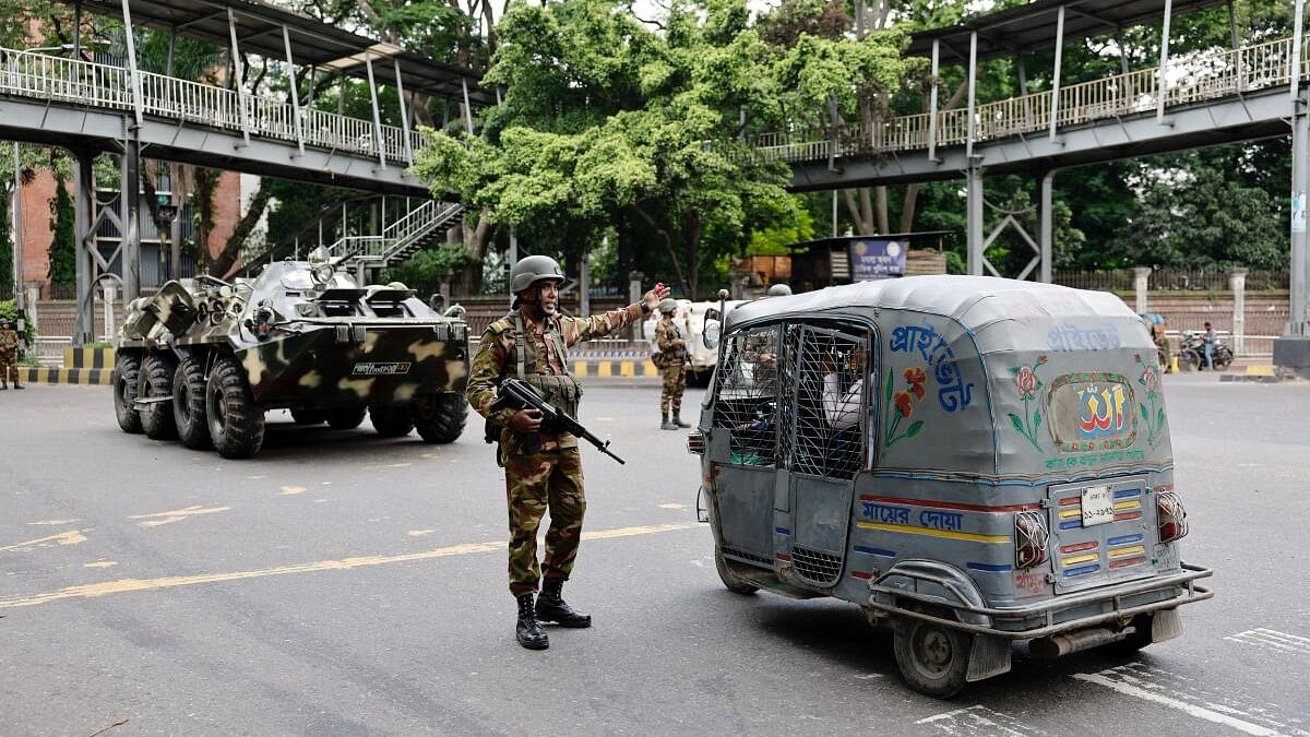 <div class="paragraphs"><p>Members of the Bangladesh Army are seen on duty on the second day of curfew, as violence erupted in parts of the country after protests by students against government job quotas, in Dhaka, Bangladesh.</p></div>