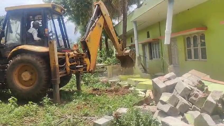 <div class="paragraphs"><p>An earthmover razes a house built on BM Kaval forest land. </p></div>