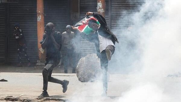 <div class="paragraphs"><p>A man holds a flag during a demonstration over police killings of people protesting against the imposition of tax hikes by the government in Nairobi, Kenya.&nbsp;</p></div>