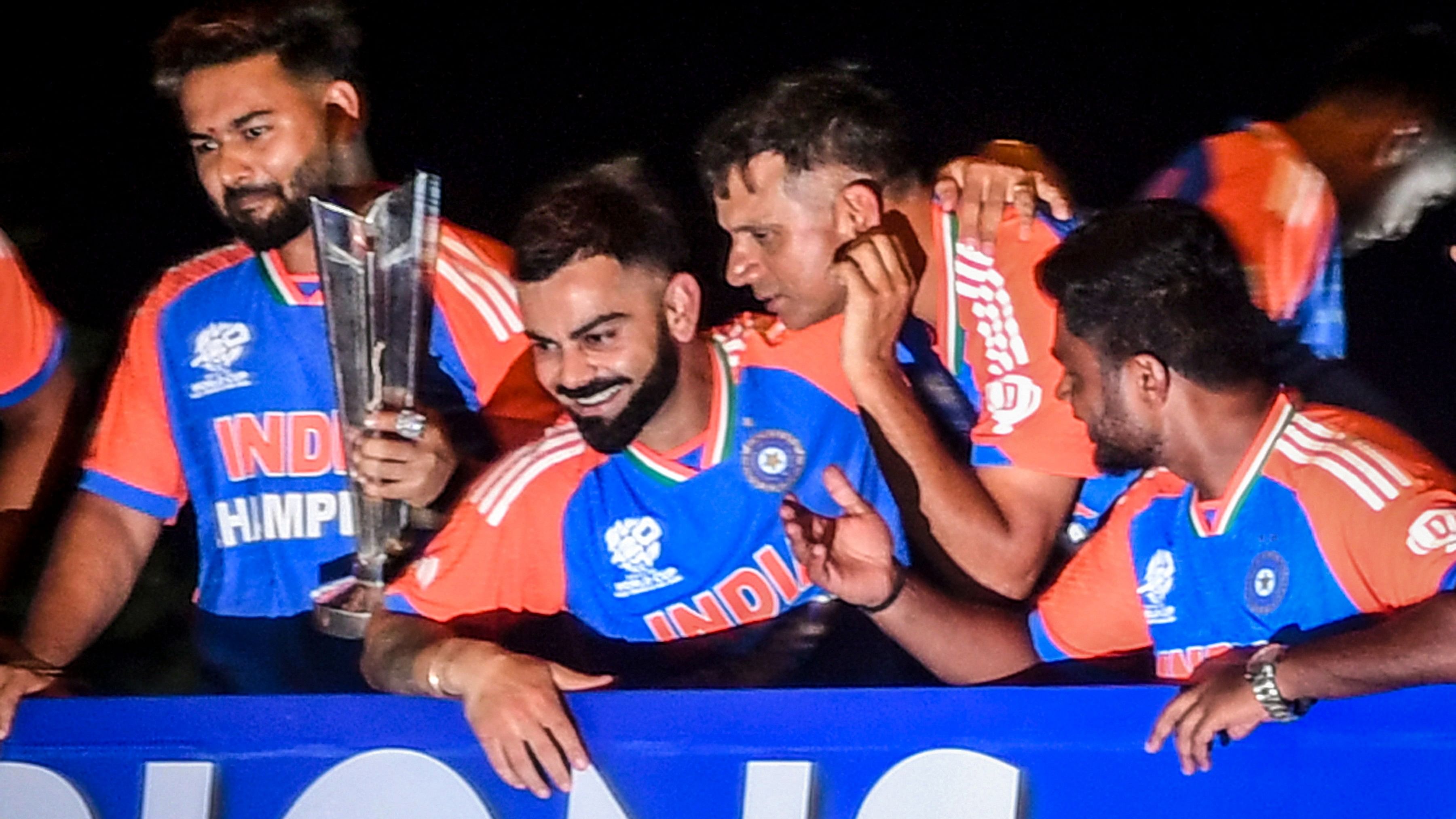 <div class="paragraphs"><p>Players of the T20 World Cup-winning Indian cricket team with the championship trophy acknowledge fans during their open bus victory parade, in Mumbai, Thursday</p></div>