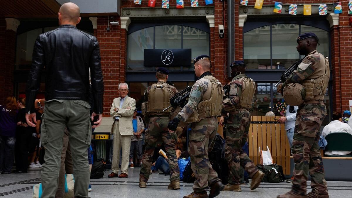 <div class="paragraphs"><p>Security personel walk at Gare de Lille-Flandres train station, after a series of coordinated actions on France's high-speed train network that brought major disruption, ahead of the Paris 2024 Olympics opening ceremony, in Lille, France, July 26, 2024.</p></div>