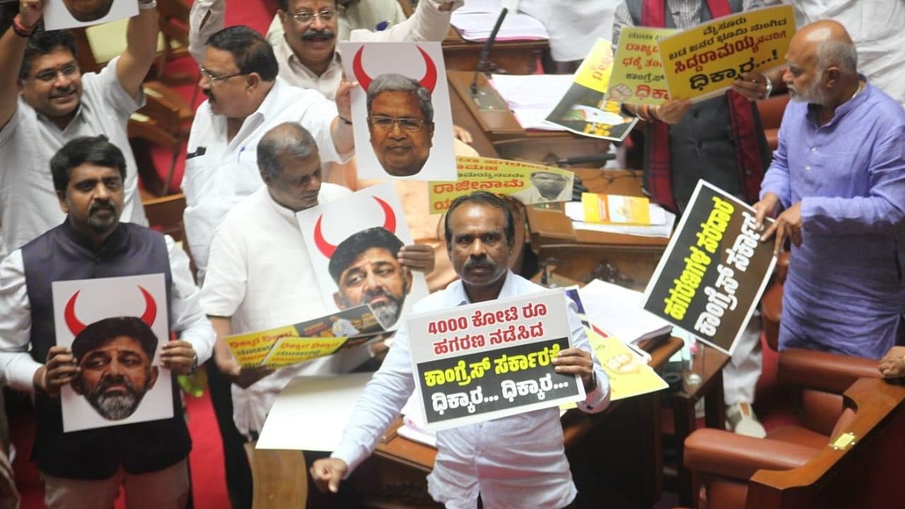 BJP member N Ravikumar and others protest against various scams of the government in the Legislative Council.