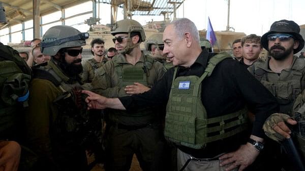 <div class="paragraphs"><p>Israeli Prime Minister Benjamin Netanyahu visits Israeli soldiers in Rafah, in the southern Gaza Strip, in this handout picture from July 18, 2024.</p></div>