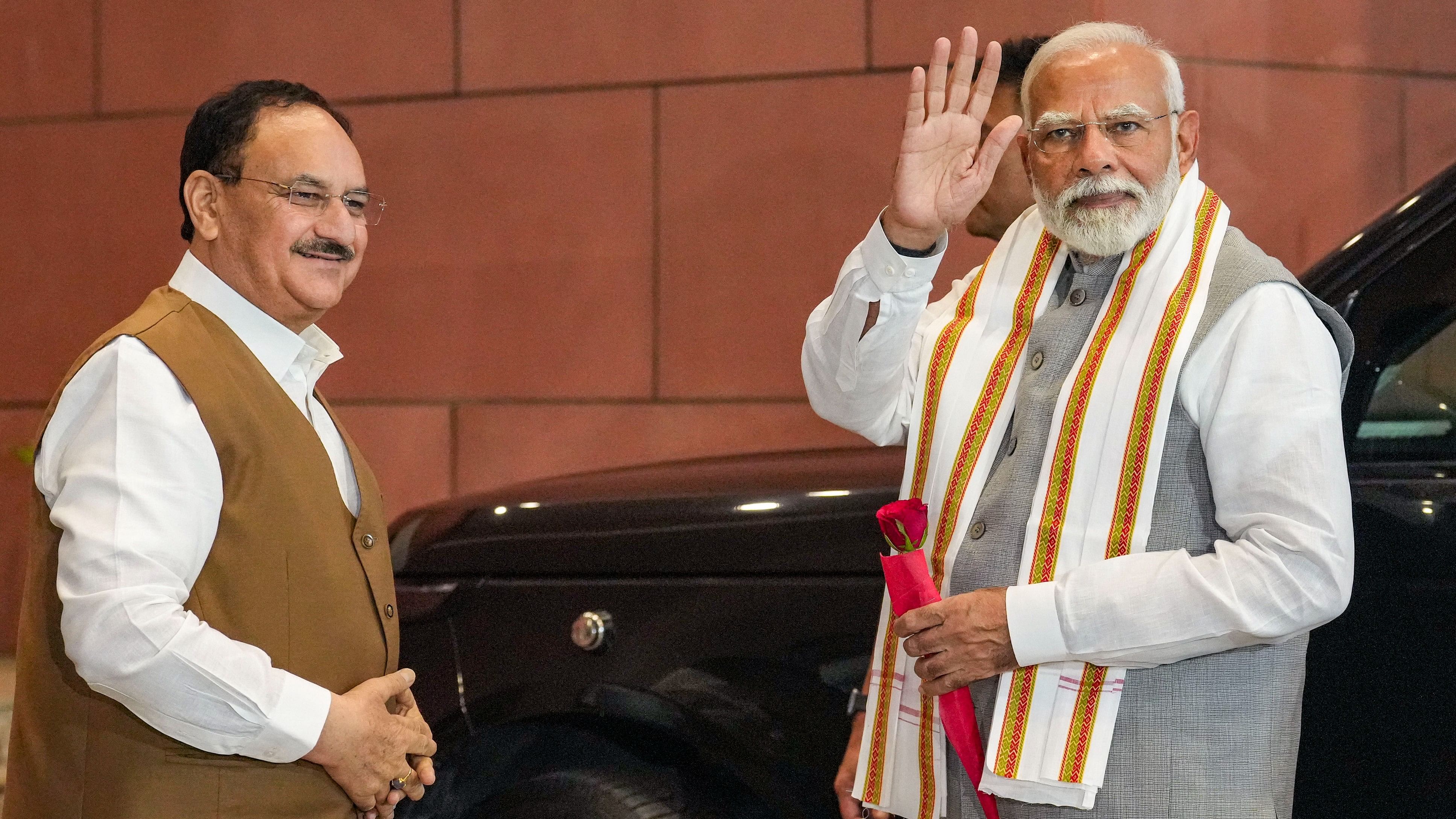 <div class="paragraphs"><p>Prime Minister Narendra Modi being welcomed by Union Minister and BJP President JP Nadda as he arrives to meet party workers at the BJP headquarters, in New Delhi, Thursday</p></div>