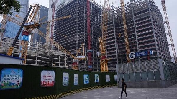 <div class="paragraphs"><p>A person walks past a construction site in Beijing's Central Business District (CBD), China July 14, 2024.</p></div>