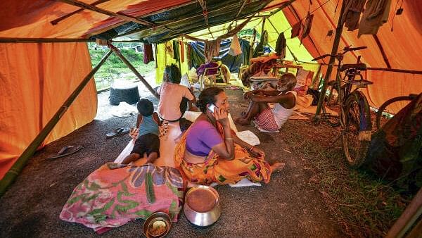 <div class="paragraphs"><p>Residents of a flood affected area take refuge in a makeshift shelter, at Kaliabor, in Nagaon district, Assam.</p></div>