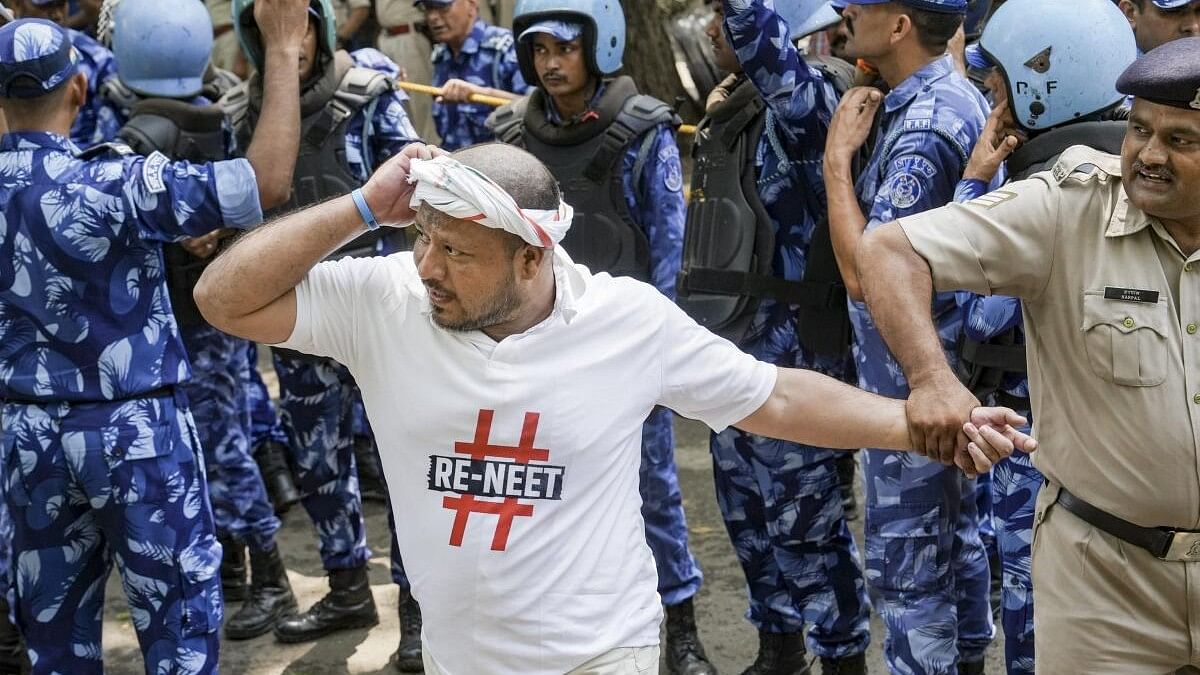 <div class="paragraphs"><p>Police and security personnel detain an Indian Youth Congress (IYC) worker during a protest at Jantar Mantar over the alleged rigging of the NEET UG exam and against the Agniveer Scheme, in New Delhi, Thursday, June 27, 2024.</p></div>