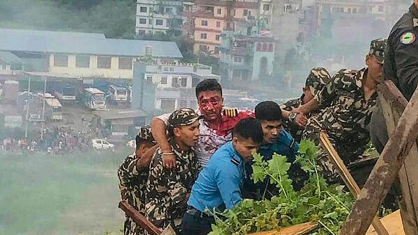 <div class="paragraphs"><p>The injured pilot of the Saurya Airlines being rescued after the Pokhara bound aircraft crashed during takeoff at the Tribhuvan International Airport (TIA), killing 18 of the 19 people on board, in Kathmandu, Wednesday, July 24, 2024.</p></div>