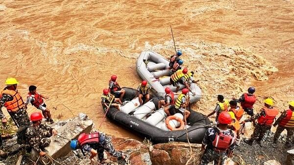 <div class="paragraphs"><p>Rescue operation underway after two buses were swept away by a landslide and pushed into a swollen river at Simaltal area along the Narayanghat-Mugling road in Chitwan district, Nepal. </p></div>