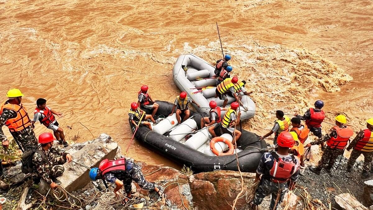 <div class="paragraphs"><p>Rescue operation underway after two buses were swept away by a landslide and pushed into a swollen river at Simaltal area along the Narayanghat-Mugling road in Chitwan district, Nepal.</p></div>