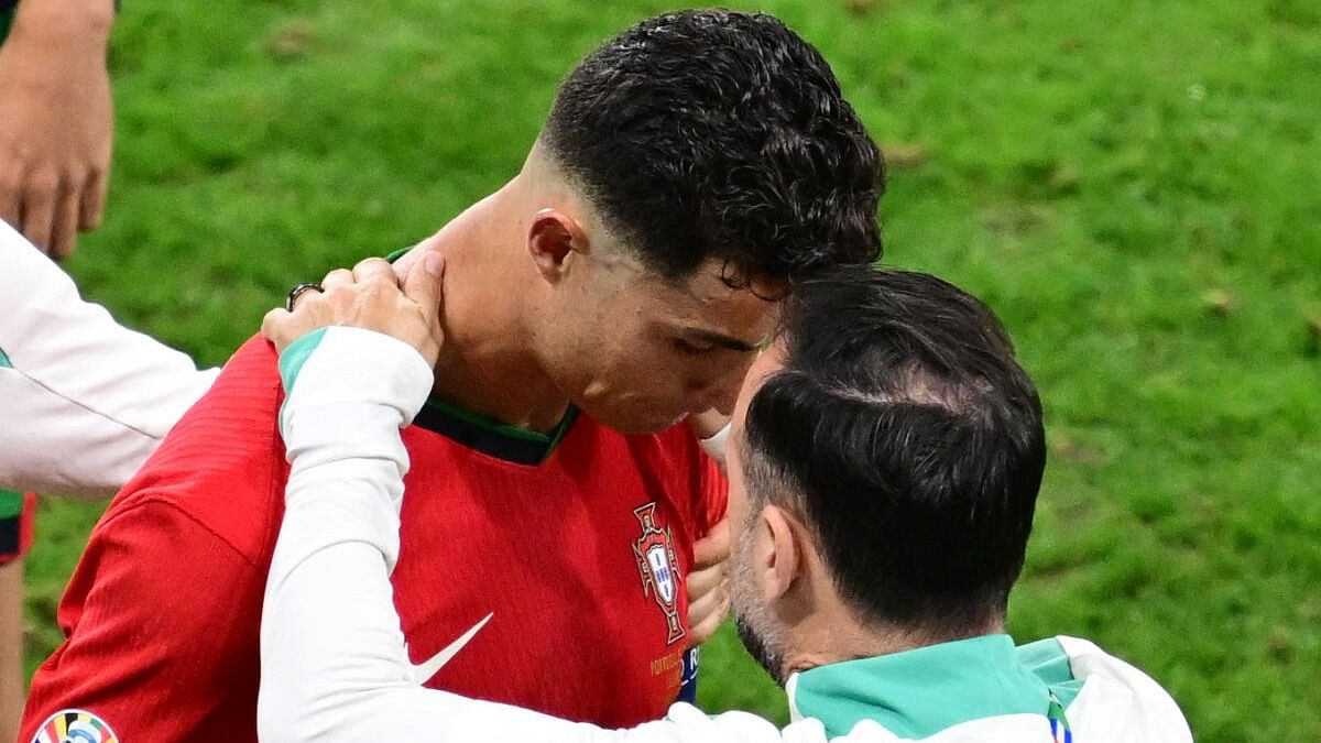 <div class="paragraphs"><p>Cristiano Ronaldo being consoled after missing the penalty against Slovenia during their round-of-16 tie.</p></div>