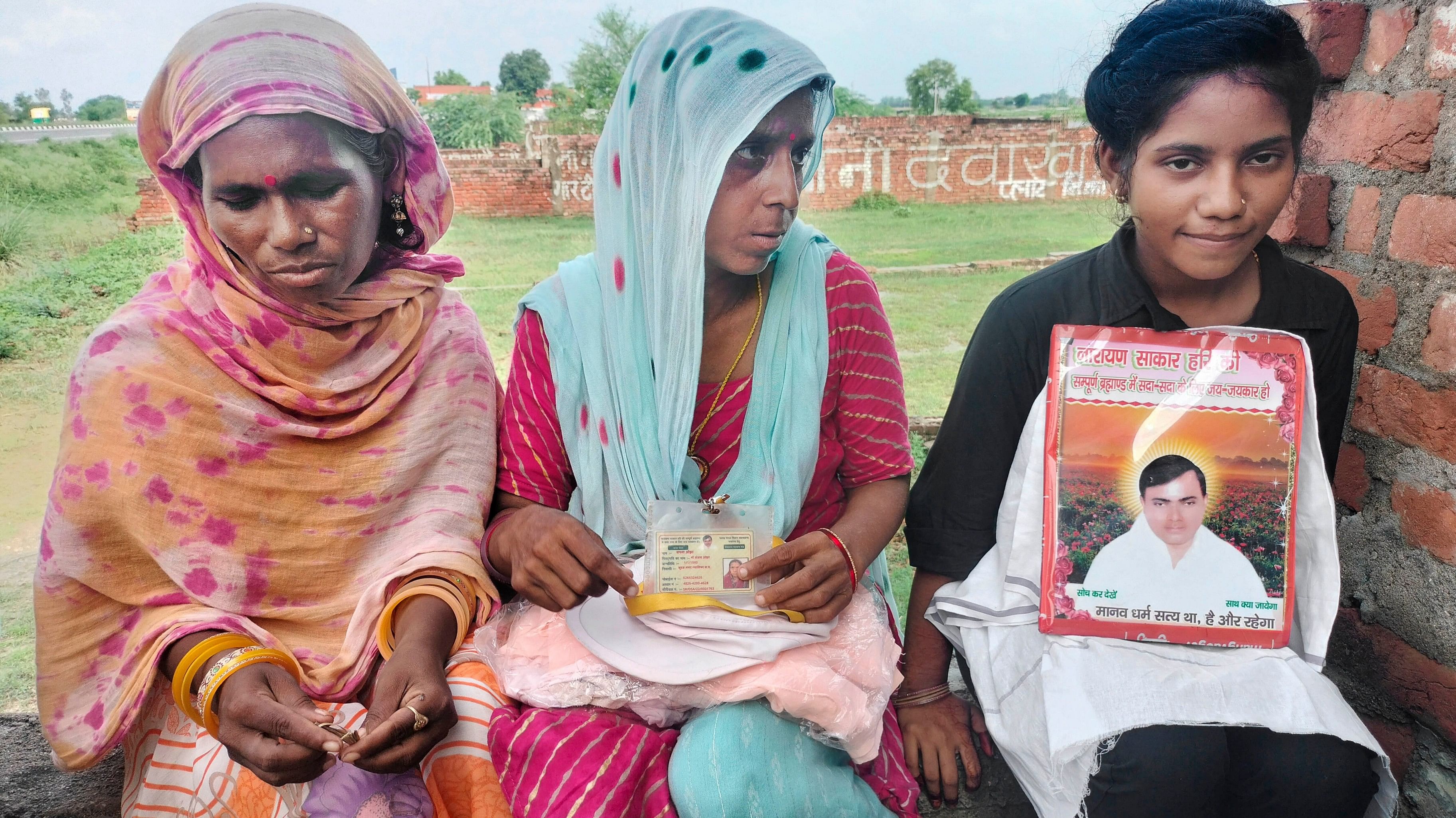 <div class="paragraphs"><p>Devotees sit with a picture of preacher Surajpal alias Narayan Sakar Hari alias Bhole Baba at his 'ashram', in Mainpuri, Thursday, July 4, 2024.  </p></div>