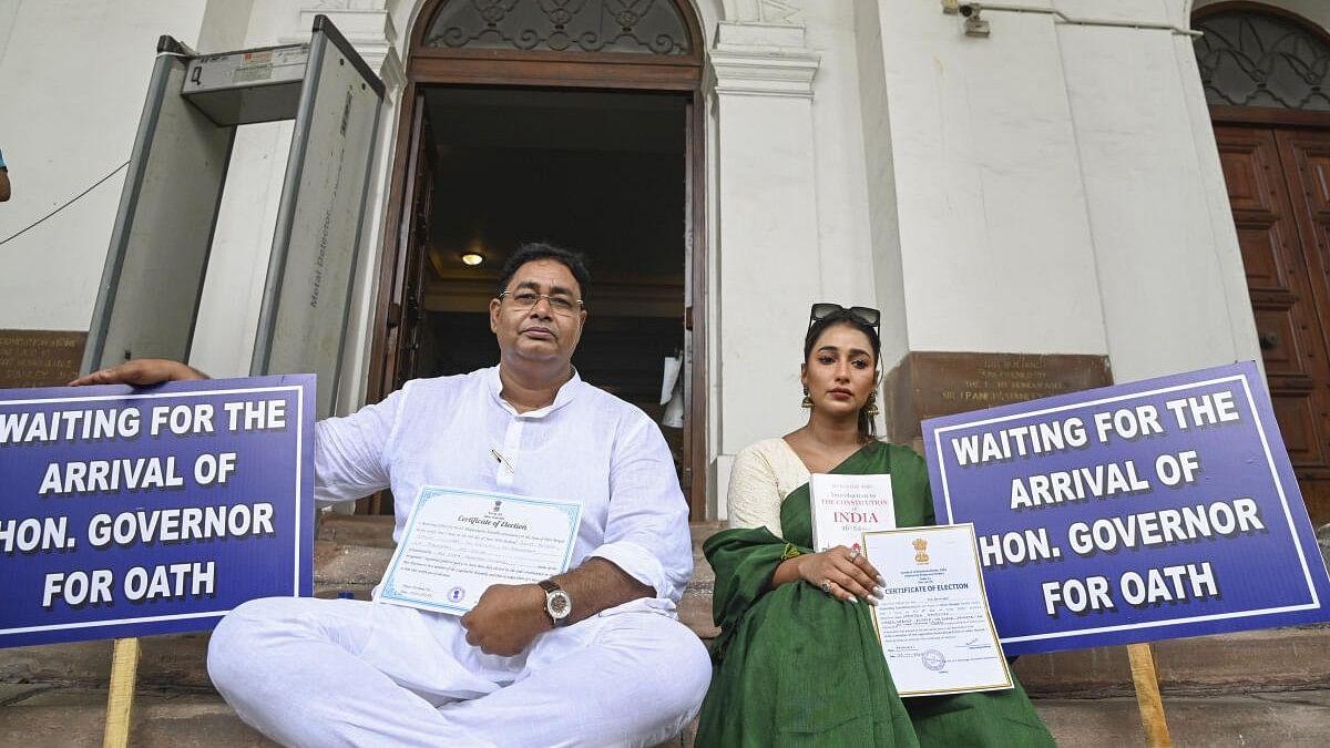 <div class="paragraphs"><p>In this image take on June 26, Rayat Hossain Sarkar (left) and Sayantika Banerjee wait on the West Bengal Legislative Assembly premises for their swearing-in ceremony.</p></div>