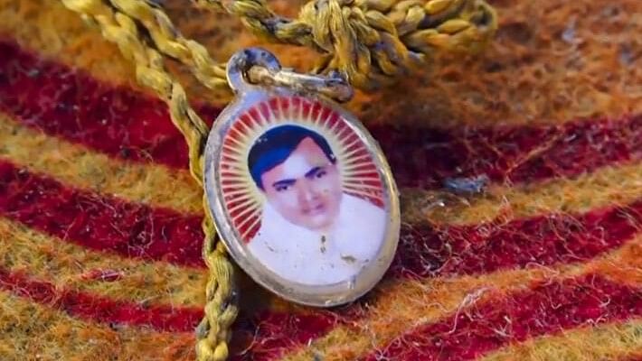 <div class="paragraphs"><p>A locket depicting Suraj Pal Singh aka Bhole Baba at the spot  after a massive stampede took place during a 'satsang' (religious congregation), in Sikandara Rao area in Hathras district.</p></div>