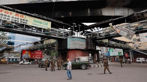 <div class="paragraphs"><p>Army soldiers stand guard under a footbridge that was set on fire by a mob during clashes in Bangladesh. (file photo)</p></div>